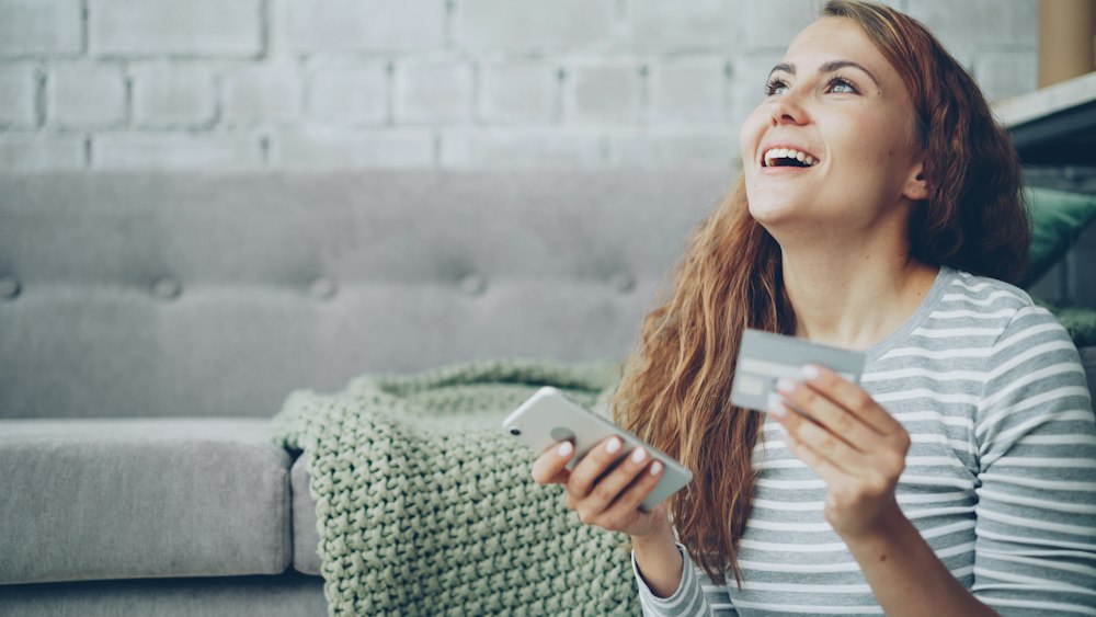 A happy customer reviewing their bill on a phone